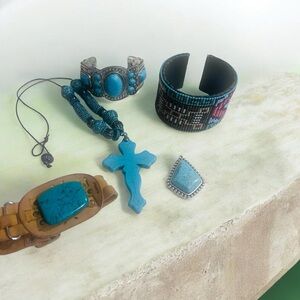3 bracelets 1 pendant & 1 cross necklace.  Turquoise and silver colored